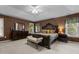Main bedroom with tray ceiling, dark brown walls, carpet flooring, and decorative furniture at 708 Cheselden Dr, Durham, NC 27713