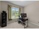 Well-lit office space with carpet, desk, and large window view at 708 Cheselden Dr, Durham, NC 27713