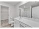 Bright bathroom with dual sink vanity, white cabinets, framed mirror, and natural light at 717 Little Patch St, Zebulon, NC 27597