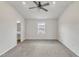Spacious bedroom with ceiling fan, plush carpeting, large windows, and natural light at 717 Little Patch St, Zebulon, NC 27597
