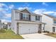 Two-story home with vinyl siding, stone accents, a two-car garage, and a well-kept lawn at 717 Little Patch St, Zebulon, NC 27597