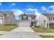 Two-story house with vinyl siding, stone accents, well-kept lawn, and a paved driveway at 717 Little Patch St, Zebulon, NC 27597