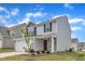 Home showcasing vinyl siding, stone accents, an established lawn, and a paved driveway at 717 Little Patch St, Zebulon, NC 27597