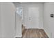 Entryway with wood floors, neutral walls, staircase and natural light from a front door sidelight window at 717 Little Patch St, Zebulon, NC 27597