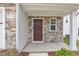 Inviting front entrance featuring stone accents, a covered porch, and a stylish, paneled front door at 717 Little Patch St, Zebulon, NC 27597