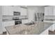 Bright kitchen features granite countertops, stainless steel appliances, and ample white cabinetry at 717 Little Patch St, Zebulon, NC 27597
