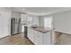 Well-lit kitchen with granite counters, stainless steel appliances, and kitchen island/breakfast bar at 717 Little Patch St, Zebulon, NC 27597