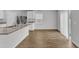 Bright kitchen featuring granite counters, stainless steel appliances, and modern wood flooring at 717 Little Patch St, Zebulon, NC 27597