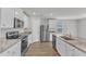 Well-equipped kitchen features stainless appliances, granite counters, and a convenient center island at 717 Little Patch St, Zebulon, NC 27597