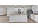 Modern kitchen boasts granite counters, stainless steel appliances, and large center island at 717 Little Patch St, Zebulon, NC 27597