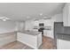 Open-concept kitchen featuring granite countertops, center island, stainless appliances and breakfast bar at 717 Little Patch St, Zebulon, NC 27597