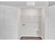 A spacious laundry room features white walls, tiled floors, and white bi-fold doors at 717 Little Patch St, Zebulon, NC 27597