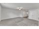 Neutral toned living room featuring carpet, ceiling fan and access to upper levels at 717 Little Patch St, Zebulon, NC 27597
