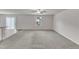 Spacious living room featuring carpet, ceiling fan, natural light from sliding glass door and window at 717 Little Patch St, Zebulon, NC 27597