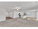Open concept living room with wood flooring, carpet and ceiling fan leading into the kitchen at 717 Little Patch St, Zebulon, NC 27597