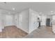 Open living area flows from the kitchen, features hardwood floors, and white interior doors at 717 Little Patch St, Zebulon, NC 27597