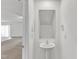 Powder room showcasing a pedestal sink, a framed mirror, and minimalist decor at 717 Little Patch St, Zebulon, NC 27597