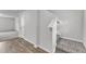 Foyer with staircase, light gray carpet, neutral walls, white trim and wood look floors at 717 Little Patch St, Zebulon, NC 27597