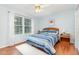 Bright bedroom with hardwood floors, a ceiling fan, and a large window that floods the room with natural light at 790 Cashmere Ct, Sanford, NC 27332