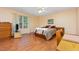 Bright bedroom features hardwood floors, ceiling fan, and natural light from the window at 790 Cashmere Ct, Sanford, NC 27332