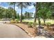 Scenic golf course view with lush green fairways, mature trees, and a water feature, creating a tranquil setting at 790 Cashmere Ct, Sanford, NC 27332