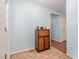 Hallway featuring an eclectic cabinet with tiled floors and pale blue walls at 790 Cashmere Ct, Sanford, NC 27332