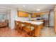 Well-lit kitchen with an island and barstool seating, stainless steel appliances, and granite countertops at 790 Cashmere Ct, Sanford, NC 27332