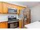 Kitchen featuring stainless steel appliances, including a refrigerator, microwave, and oven with a black cooktop at 790 Cashmere Ct, Sanford, NC 27332