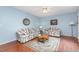 Comfortable living room featuring floral furniture, wood floors, and natural light at 790 Cashmere Ct, Sanford, NC 27332