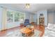 Bright living room with a large window, wooden floors and light blue walls at 790 Cashmere Ct, Sanford, NC 27332