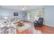 Bright, floral living room with light hardwood floors, and natural light from a large window at 790 Cashmere Ct, Sanford, NC 27332