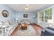 Bright living room with a ceiling fan, wood floors, and large windows offering an outdoor view at 790 Cashmere Ct, Sanford, NC 27332