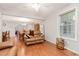 Cozy living room with wood flooring, a leather sofa, and a ceiling fan for added comfort at 790 Cashmere Ct, Sanford, NC 27332