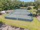 Aerial shot of multiple tennis courts nestled in a lush green landscape, promoting an active lifestyle at 790 Cashmere Ct, Sanford, NC 27332