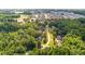 Aerial view showcases a community of homes surrounded by lush greenery and farmland at 7932 Twin Pines Way, Fuquay Varina, NC 27526