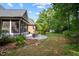 Brick home with screen porch, patio with dining set, and lush green lawn at 7932 Twin Pines Way, Fuquay Varina, NC 27526