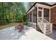 Brick home with screened-in porch and patio including an outdoor dining set at 7932 Twin Pines Way, Fuquay Varina, NC 27526