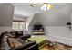 Bonus room featuring a large leather sofa, window seat, media center, ceiling fan, and carpeted floors at 7932 Twin Pines Way, Fuquay Varina, NC 27526