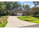 Charming brick home with a long driveway leading to the garage at 7932 Twin Pines Way, Fuquay Varina, NC 27526