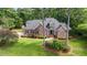 Aerial view of a brick home surrounded by a well-maintained lawn and mature trees at 7932 Twin Pines Way, Fuquay Varina, NC 27526