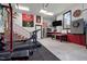 Finished garage includes gym equipment, TV, dart board, fridge, work bench, and accent wall paint at 7932 Twin Pines Way, Fuquay Varina, NC 27526