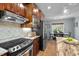 Eat-in kitchen featuring stainless appliances, wooden cabinets and a view of the dining area at 7932 Twin Pines Way, Fuquay Varina, NC 27526