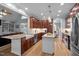 Open-concept kitchen featuring stainless steel appliances, granite countertops, and dark wood cabinets at 7932 Twin Pines Way, Fuquay Varina, NC 27526