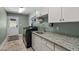 Functional laundry room with modern washer and dryer, ample counter space, and storage cabinets at 7932 Twin Pines Way, Fuquay Varina, NC 27526