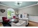 Cozy living room featuring large arched window, hardwood floors and ample seating at 7932 Twin Pines Way, Fuquay Varina, NC 27526