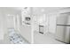 A modern kitchen with stainless steel appliances connects to a hallway at 800 Pritchard Avenue Ext # H3, Chapel Hill, NC 27516