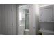 Hallway view of a modern bathroom with a stackable washer and dryer unit at 800 Pritchard Avenue Ext # H4, Chapel Hill, NC 27516
