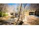 A serene view of a creek flowing through a lush, green space, with a tunnel and trail nearby at 800 Pritchard Avenue Ext # H4, Chapel Hill, NC 27516