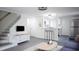 Open living room layout with modern lighting, gray flooring, and an inviting atmosphere at 800 Pritchard Avenue Ext # H4, Chapel Hill, NC 27516