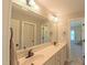 Bathroom with double sinks, an over-sized mirror, and a neutral color palette at 8042 Hogan Dr, Wake Forest, NC 27587